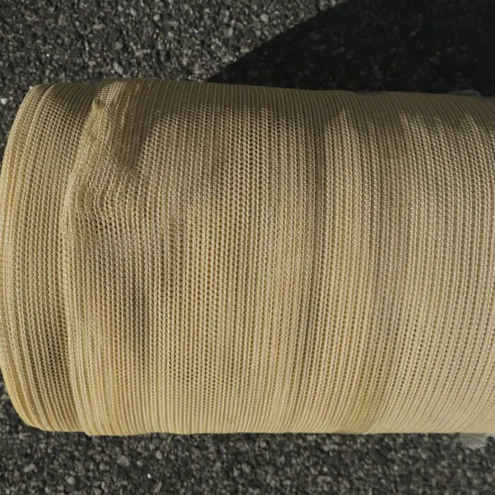 A roll of beige shadecloth