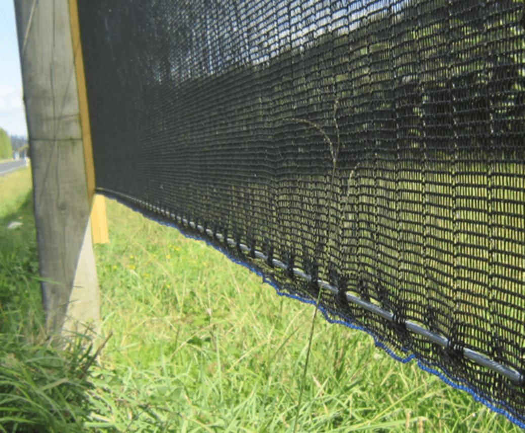 A black mesh covering is shown in the grass.